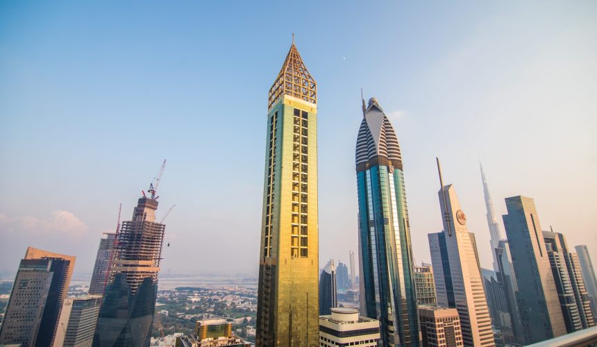 Scenic aerial view downtown Dubai, United Arab Emirates with skyscrapers and highways. Colourful travel background.